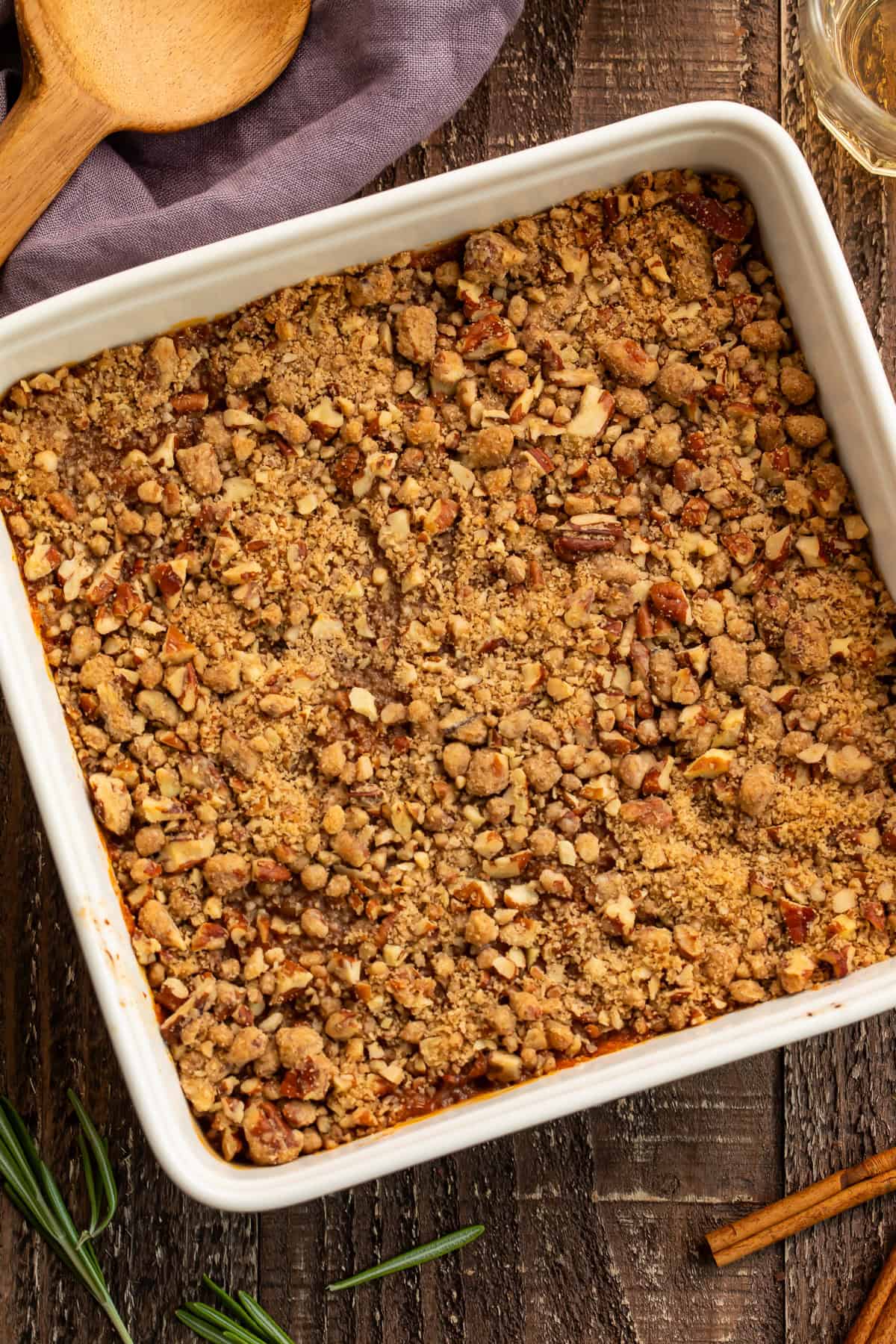Overhead shot of a white square dish filled with a crunchy-topped sweet potato casserole. 