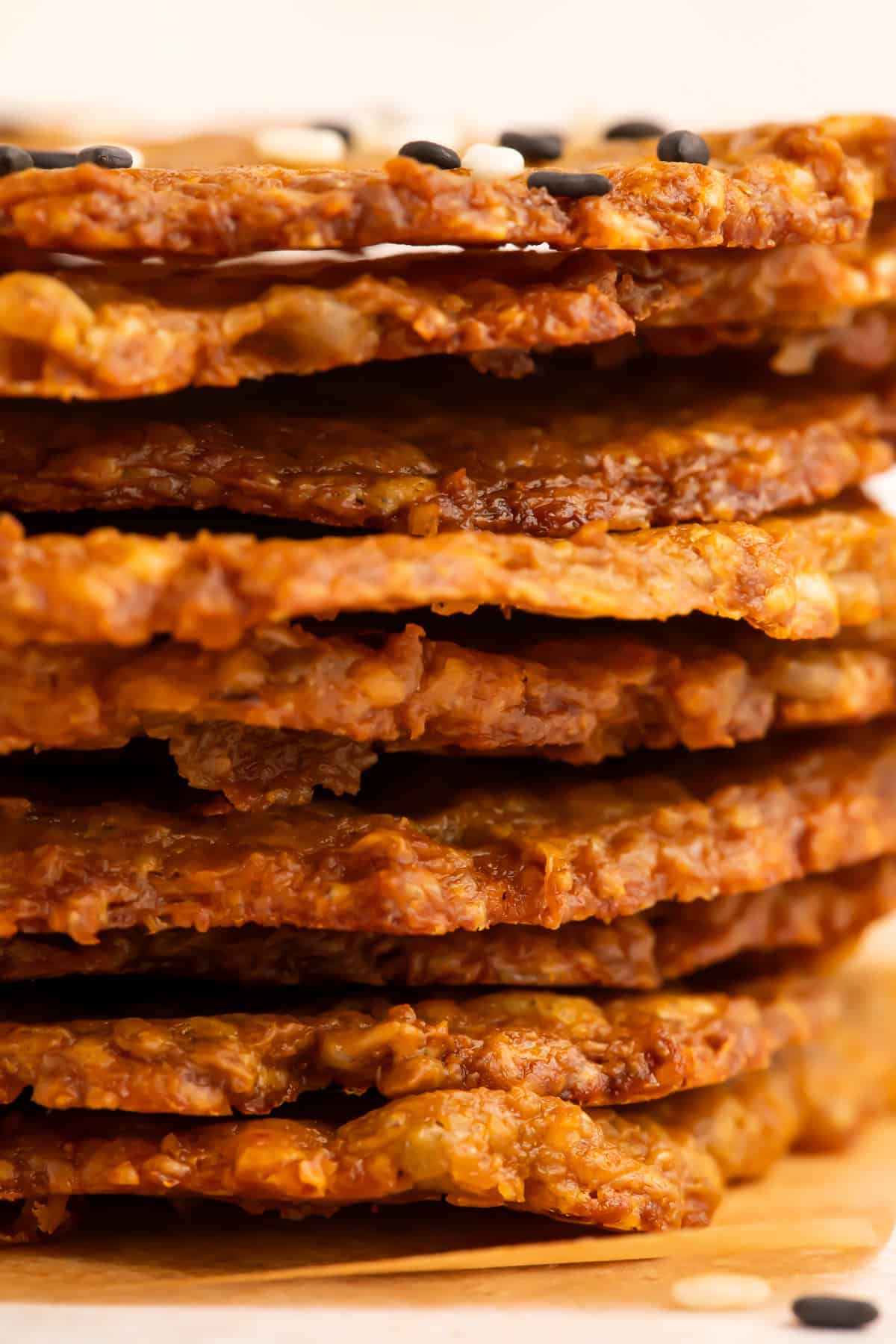 Very close up side on view of a stack of avocado chips.