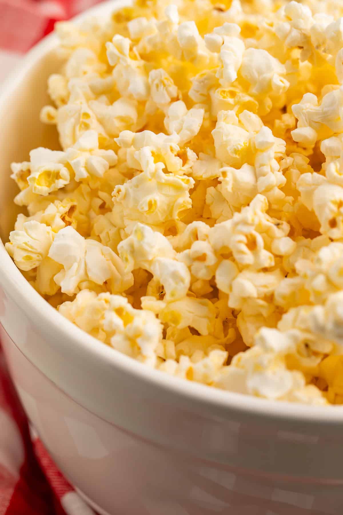 Close up of popcorn in a white serving bowl.