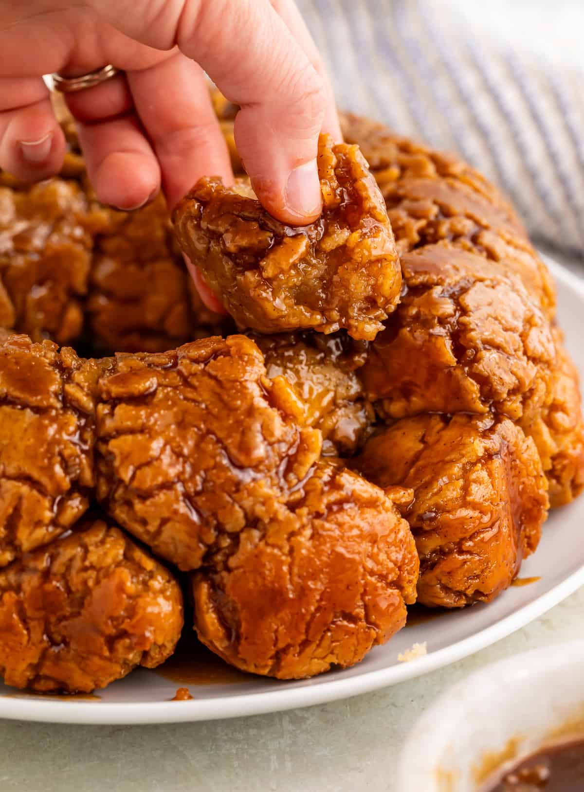 hand removing a piece of gluten-free monkey bread.