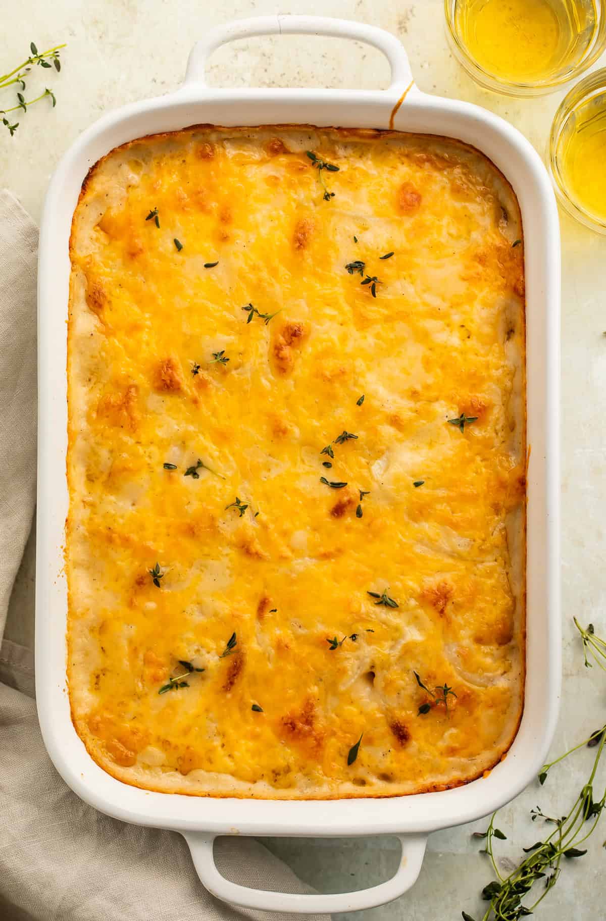 Gluten free scalloped potatoes pictured in a white baking dish.