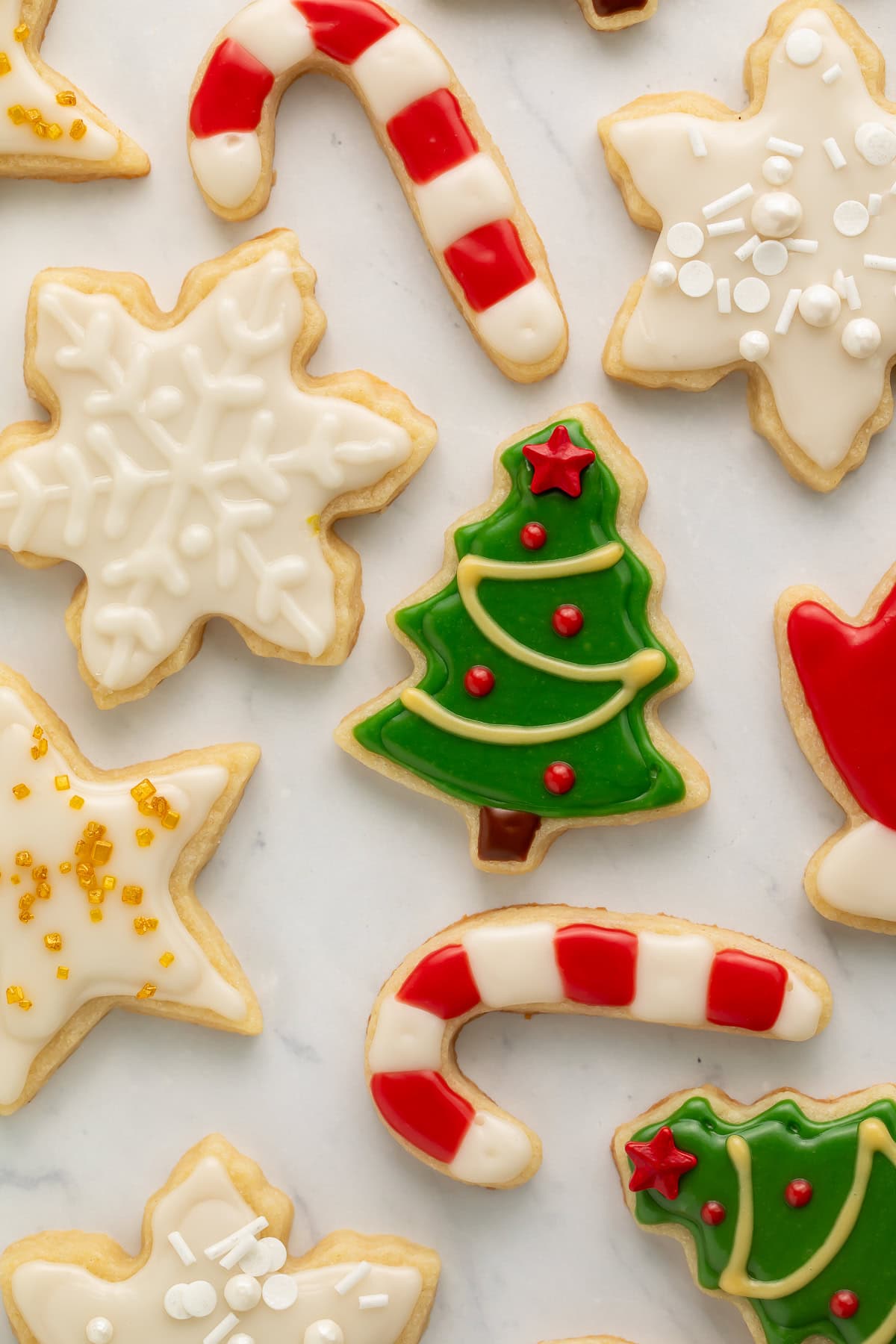 Close up of Christmas cookies with green, white, red, and yellow frosting.