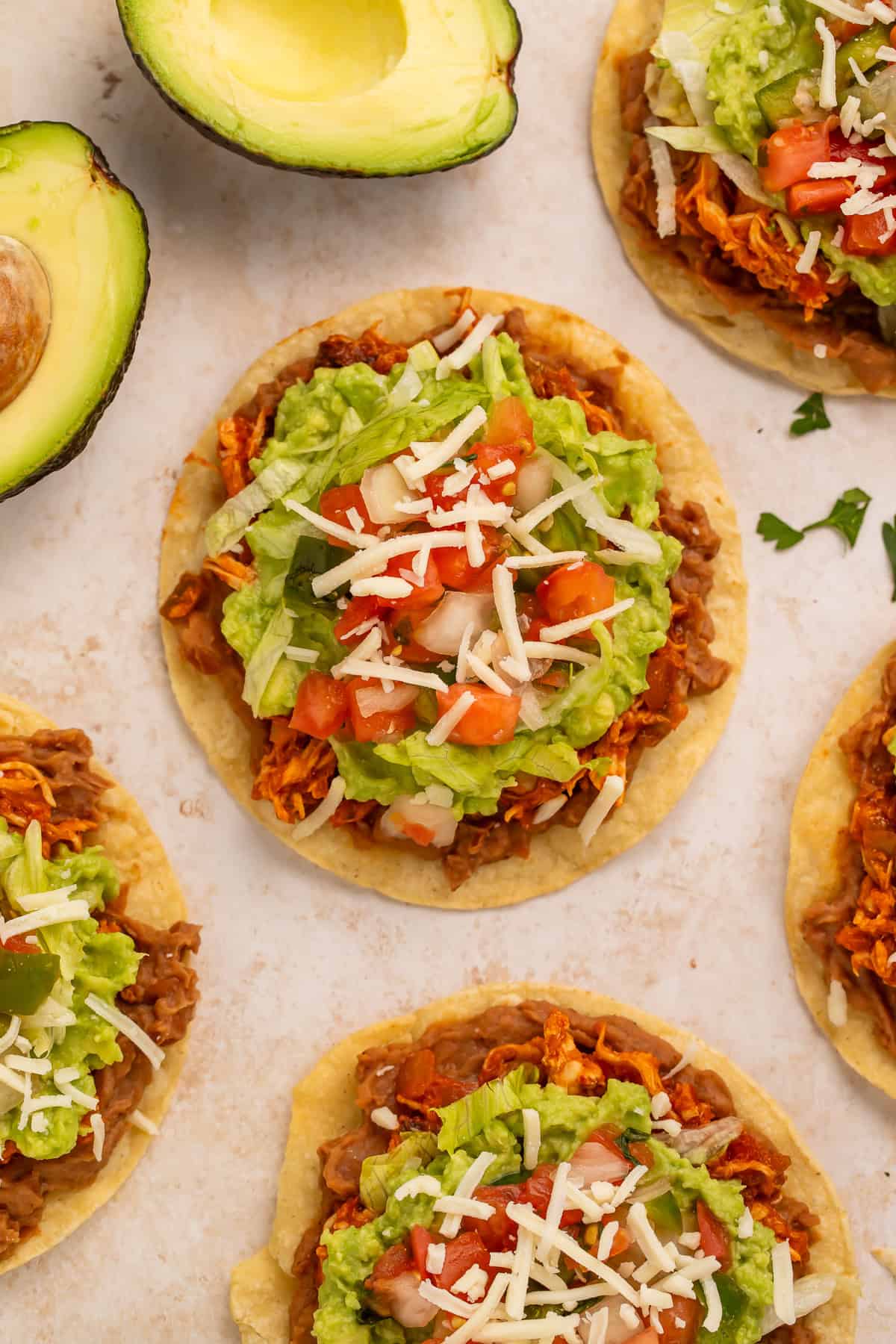 Overhead shot of tostadas and a halved avocado.