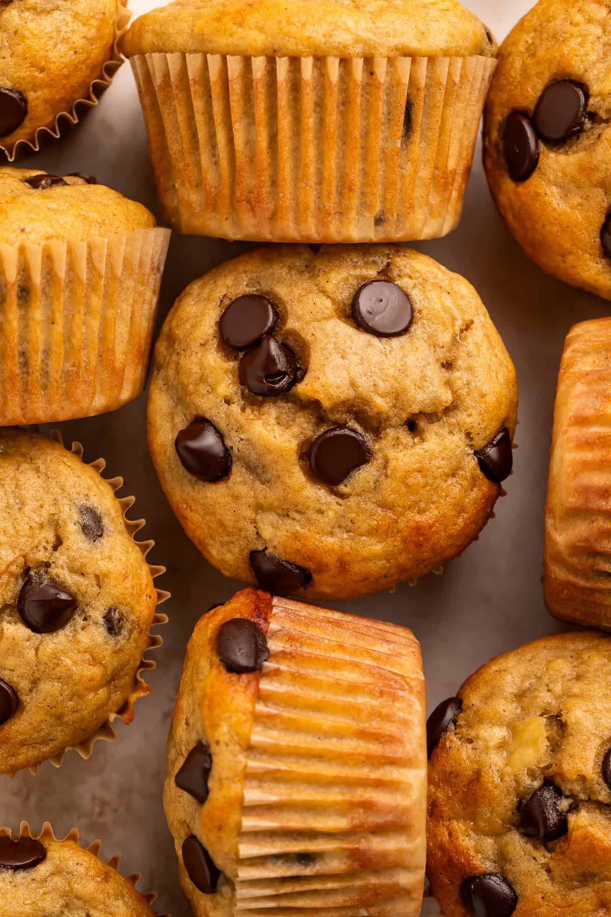 Close up of top down and side on banana muffins huddled together.