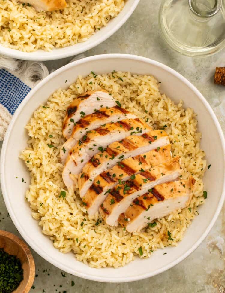 Healthy grilled chicken and rice bowl with sliced chicken breast and seasoned rice