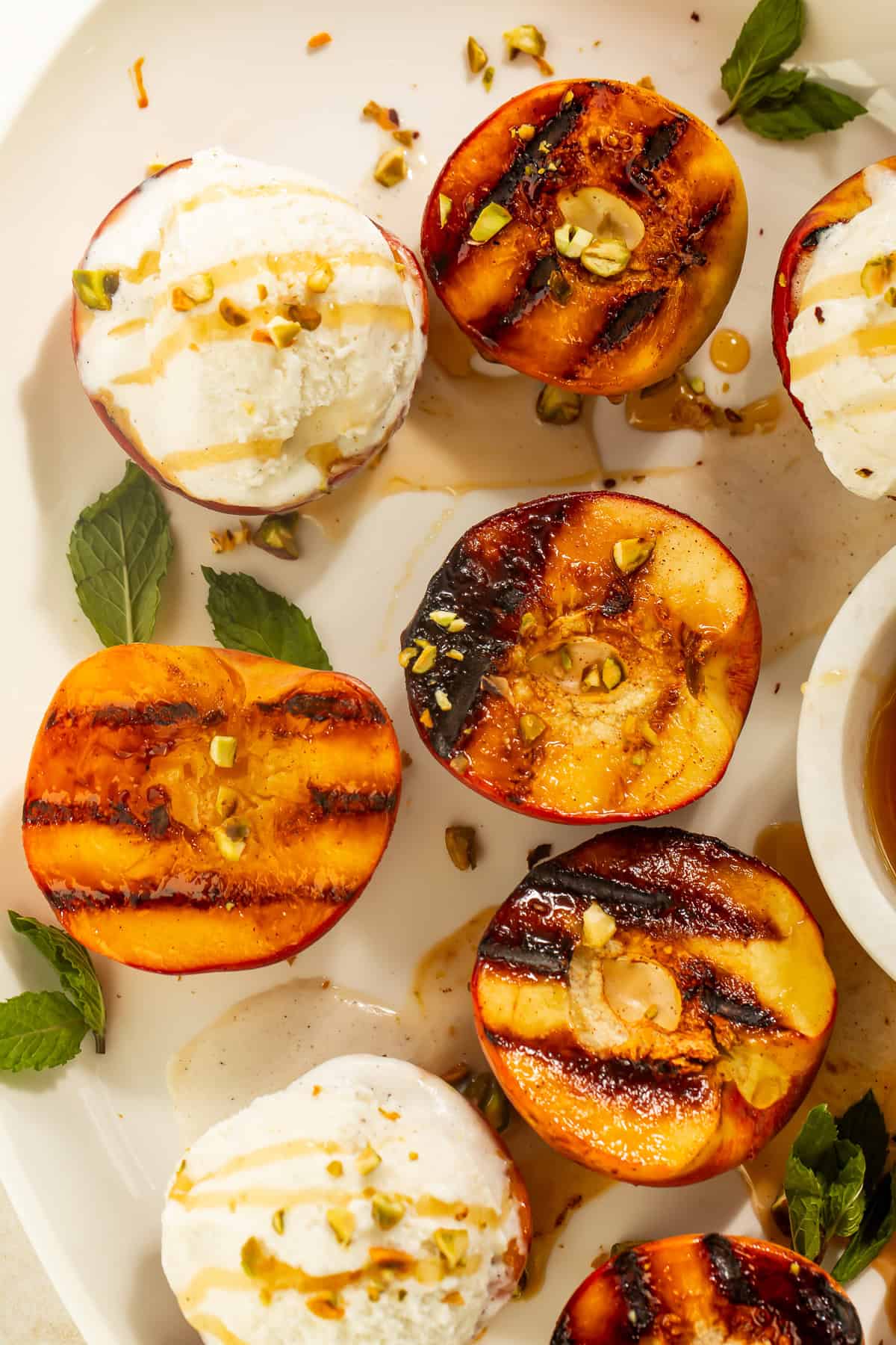 Close-up of grilled peaches and vanilla ice cream with honey drizzle