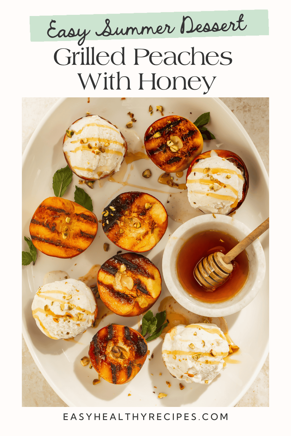Overhead view of grilled peach halves with char marks topped with vanilla ice cream, honey drizzle, and chopped pistachios