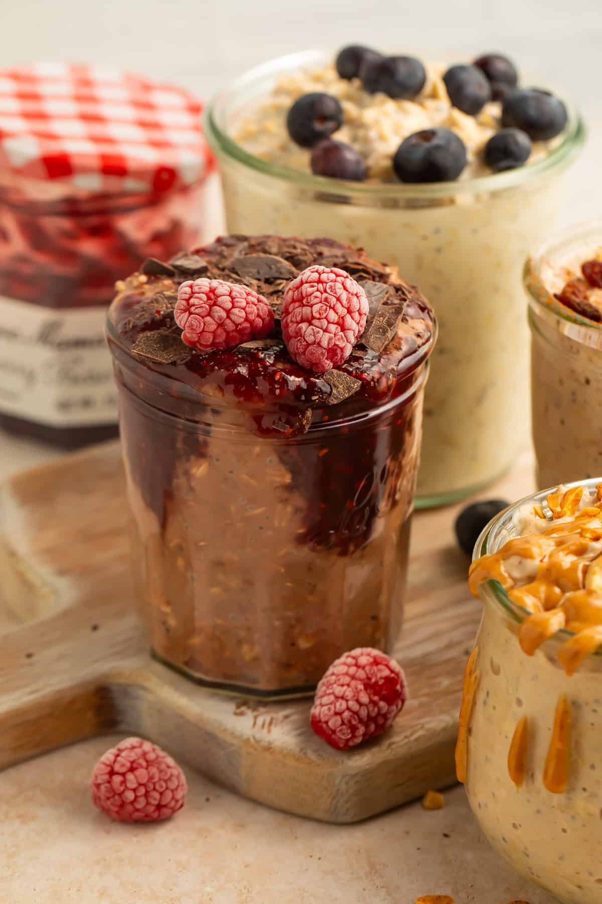 Peanut butter vegan overnight oats topped with chopped peanuts and peanut butter drizzle