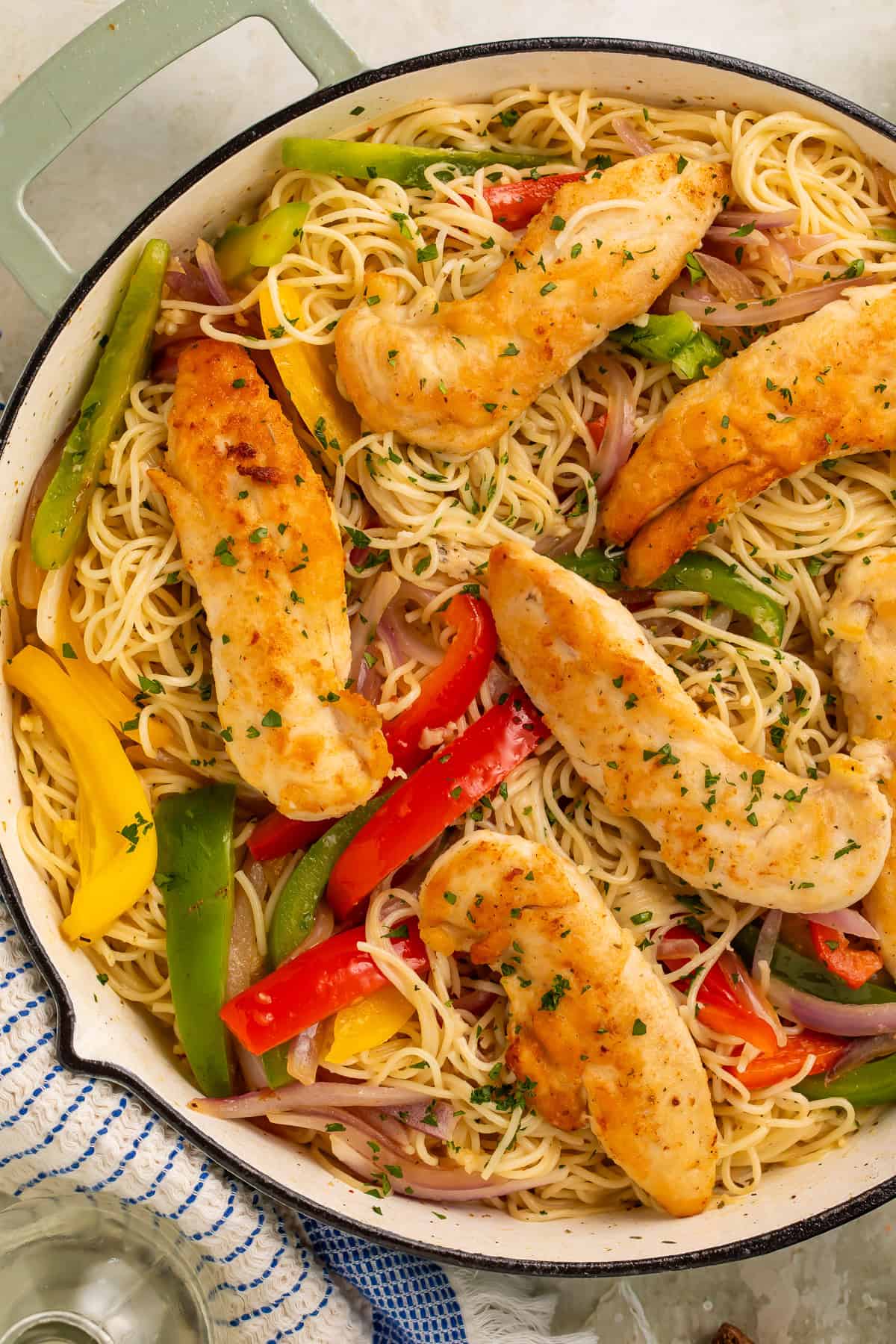 Copycat Olive Garden chicken scampi with chicken tenders, angel hair pasta, peppers, and red onion.