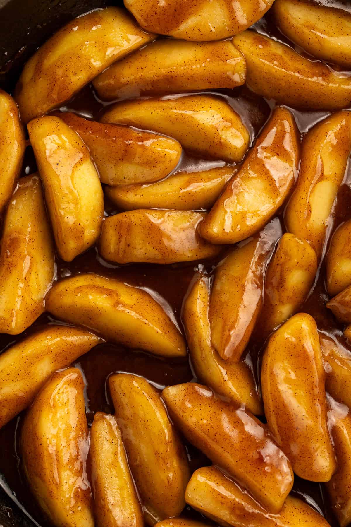 Cinnamon-glazed Cracker Barrel fried apple wedges close-up.