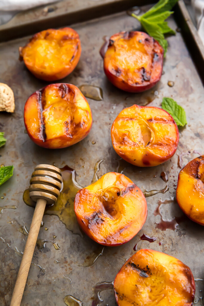 Grilled peaches on a baking sheet
