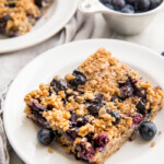 A square of blueberry baked oatmeal on a white plate