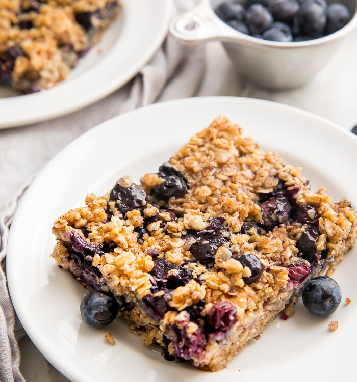 A square of blueberry baked oatmeal on a white plate