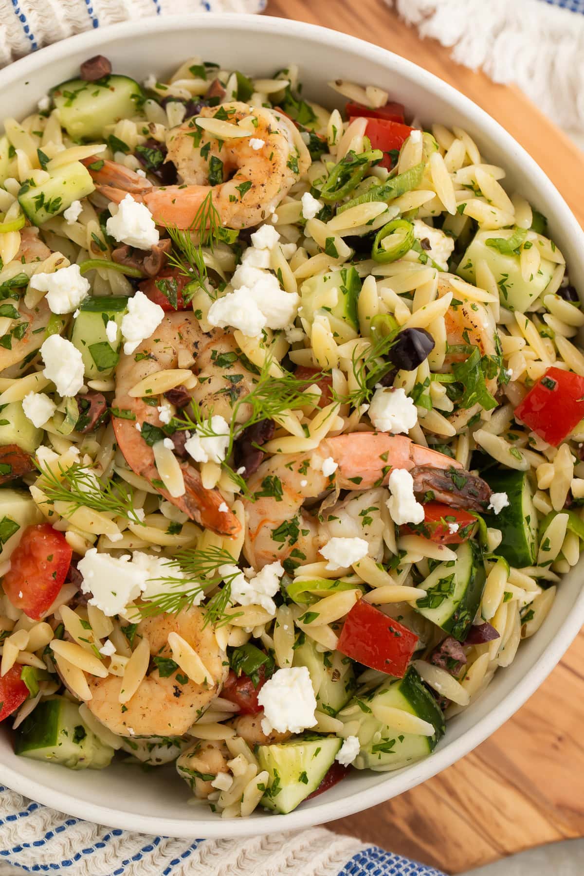 Close-up of a bowl of Greek shrimp salad with orzo.