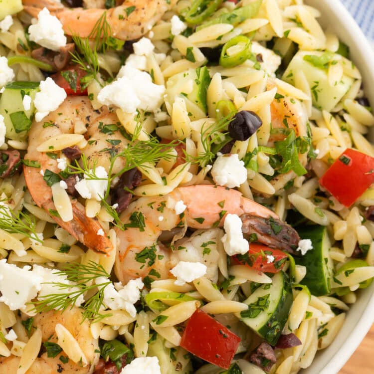 Close-up of a bowl of Greek shrimp salad with orzo.