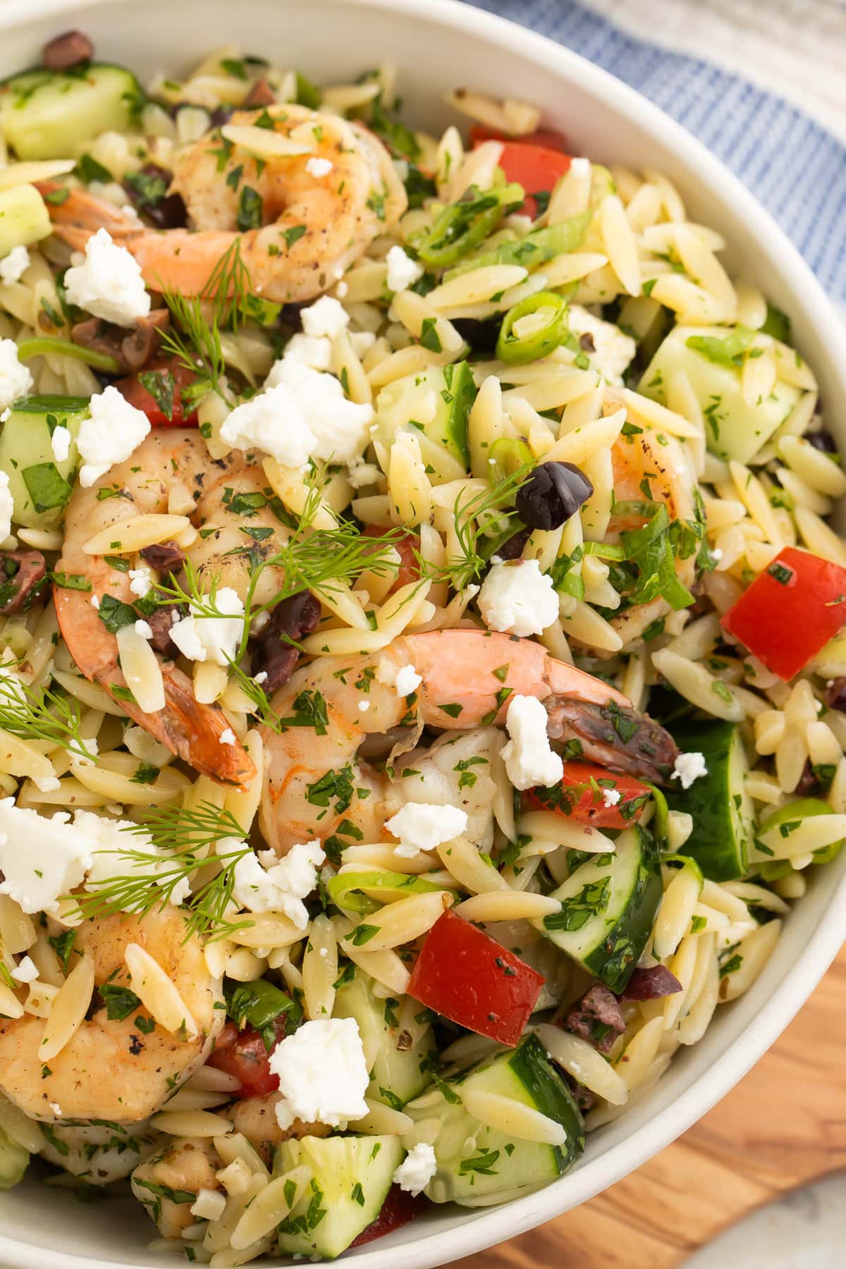 Close-up of a bowl of Greek shrimp salad with orzo.