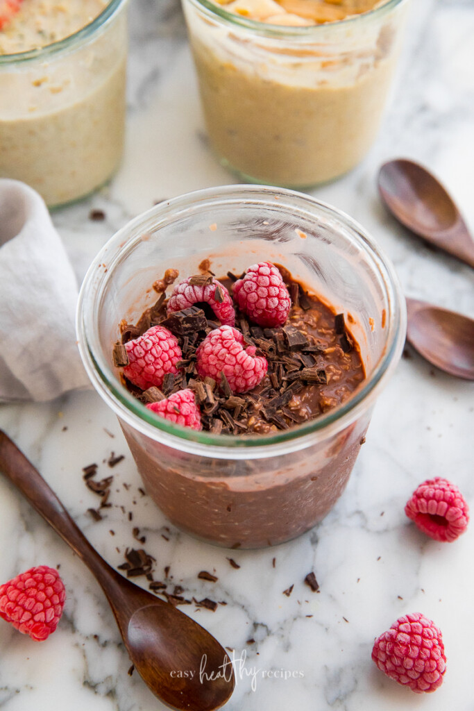 Chocolate vegan overnight oats with chocolate shavings and raspberries on top