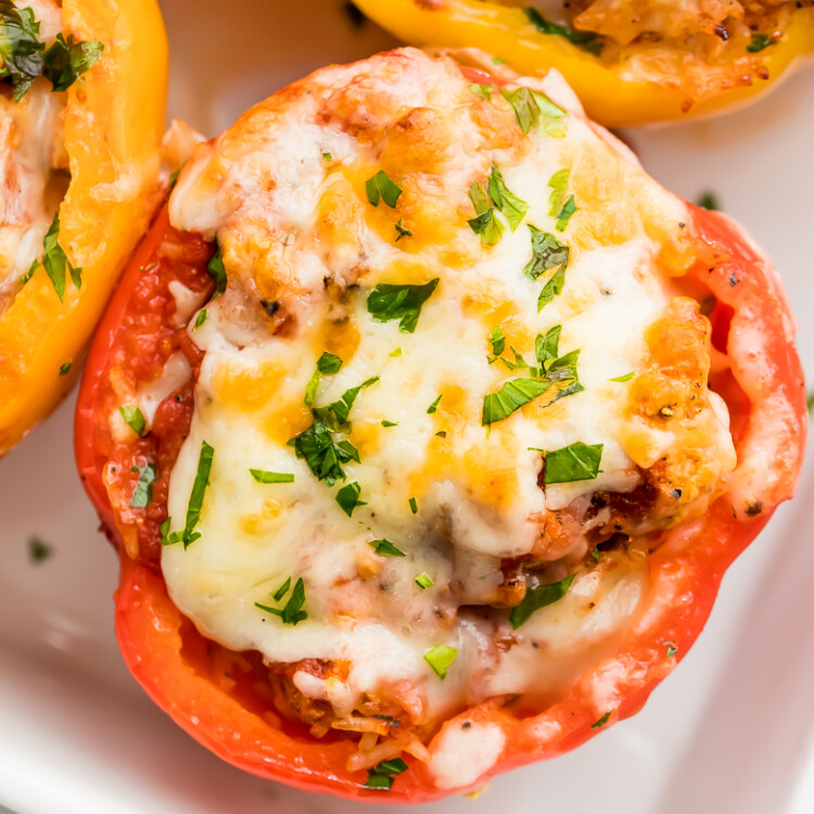 Turkey Stuffed Peppers with melted cheese and fresh parsley. Served in white dish.