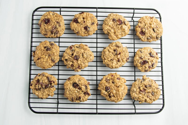 Overhead view of cranberry oatmeal cookies cooling on a wire cooling rack.