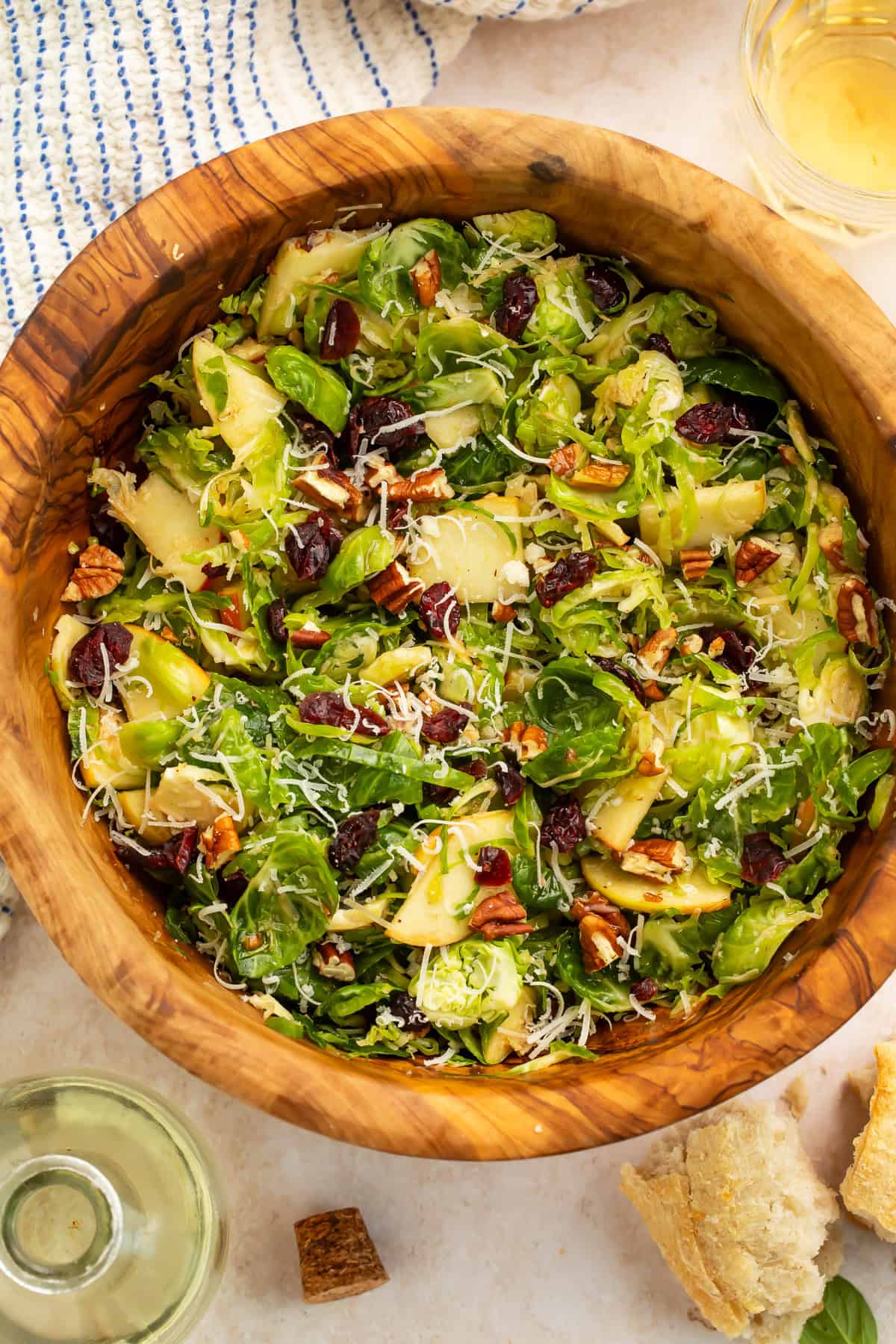 Wooden bowl of a shredded brussels sprouts salad.