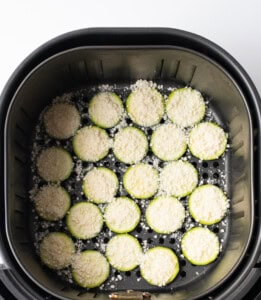 Zucchini chips with parmesan in air fryer basket