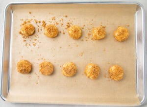Cream cheese fat bombs lined on a baking sheet to freeze