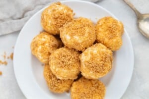 A mountain of cream cheese fat bombs on a white plate