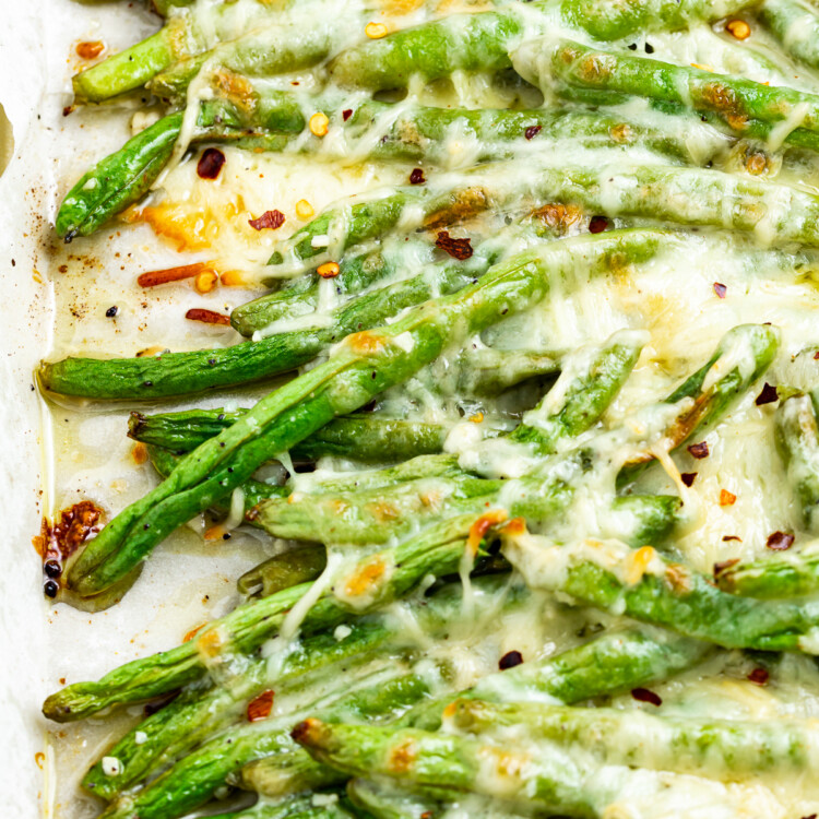 keto green beans on a baking sheet with red pepper flakes on top