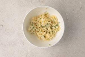 Butter, garlic, parsley, and parmesan in a bowl for garlic bread