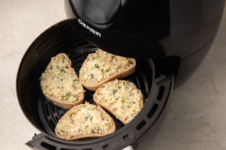 French bread with butter, garlic, parsley, and parmesan in an air fryer bowl