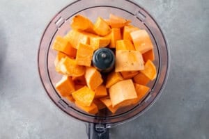 Peeled sweet potatoes in food processor