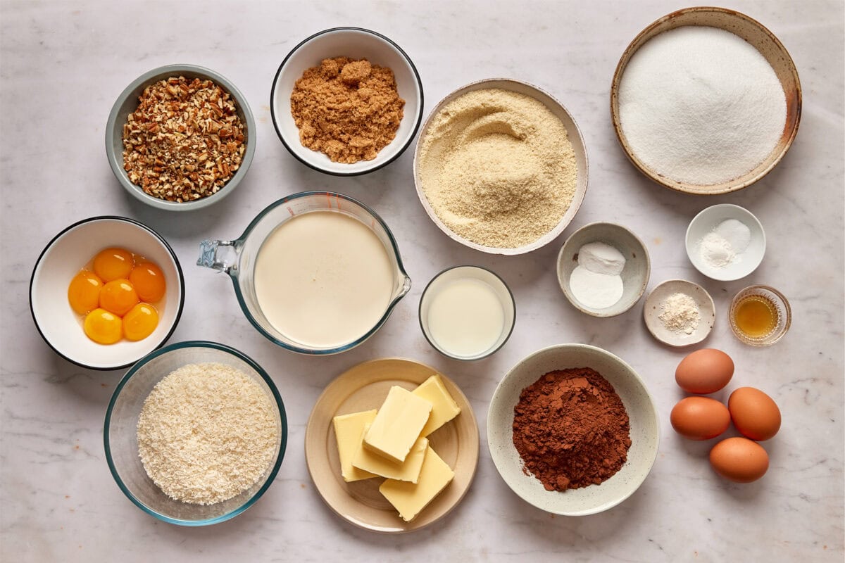 Bowls of measured ingredients to make a Keto German Chocolate Cake on the countertop. 