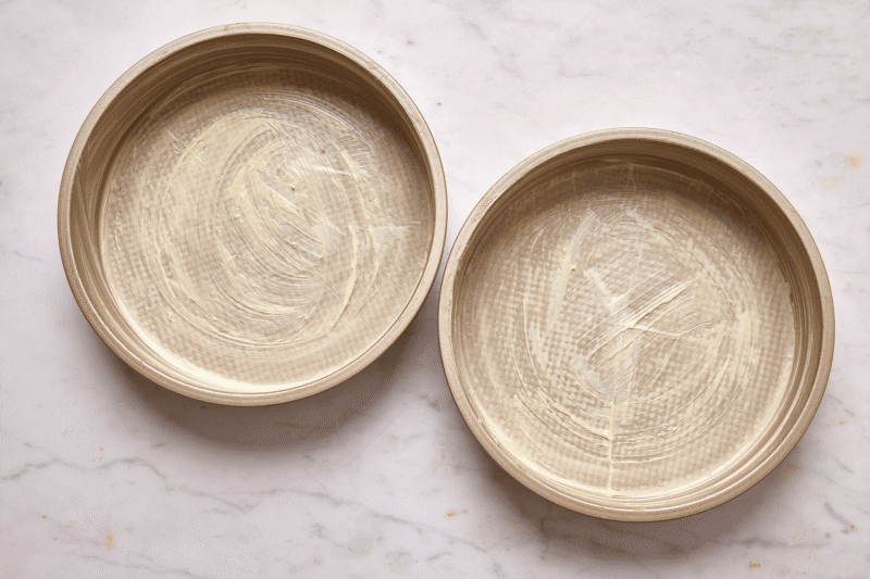 Two buttered and lined cake pans.