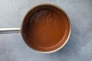 Liquid keto chocolate pudding mixture in a saucepan