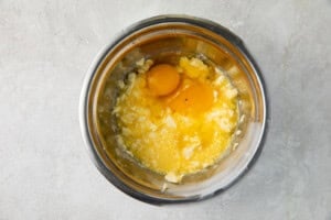 Egg and butter in a silver mixing bowl
