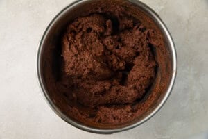 Chocolate cake batter in a silver mixing bowl
