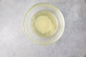 Rice vinegar, salt, white sugar, and oil in a small glass bowl for Instant Pot sushi rice