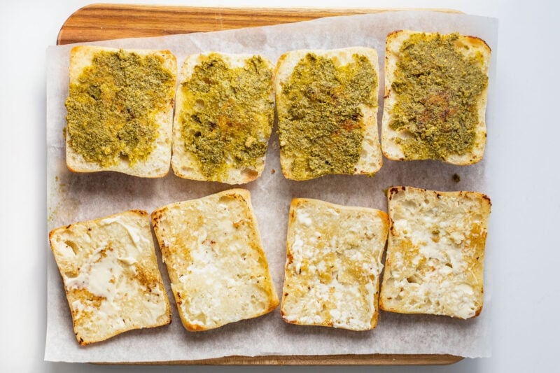 Ciabatta roll halves covered with pesto and mayo.