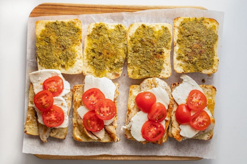 Tomato slices on top of mozzarella and chicken cutlets on ciabatta rolls.
