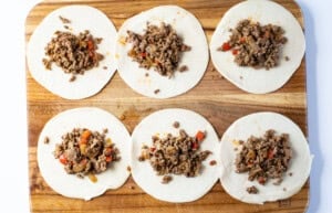 Unfolded empanadas on a cutting board