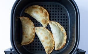 Air fryer empanadas in air fryer basket