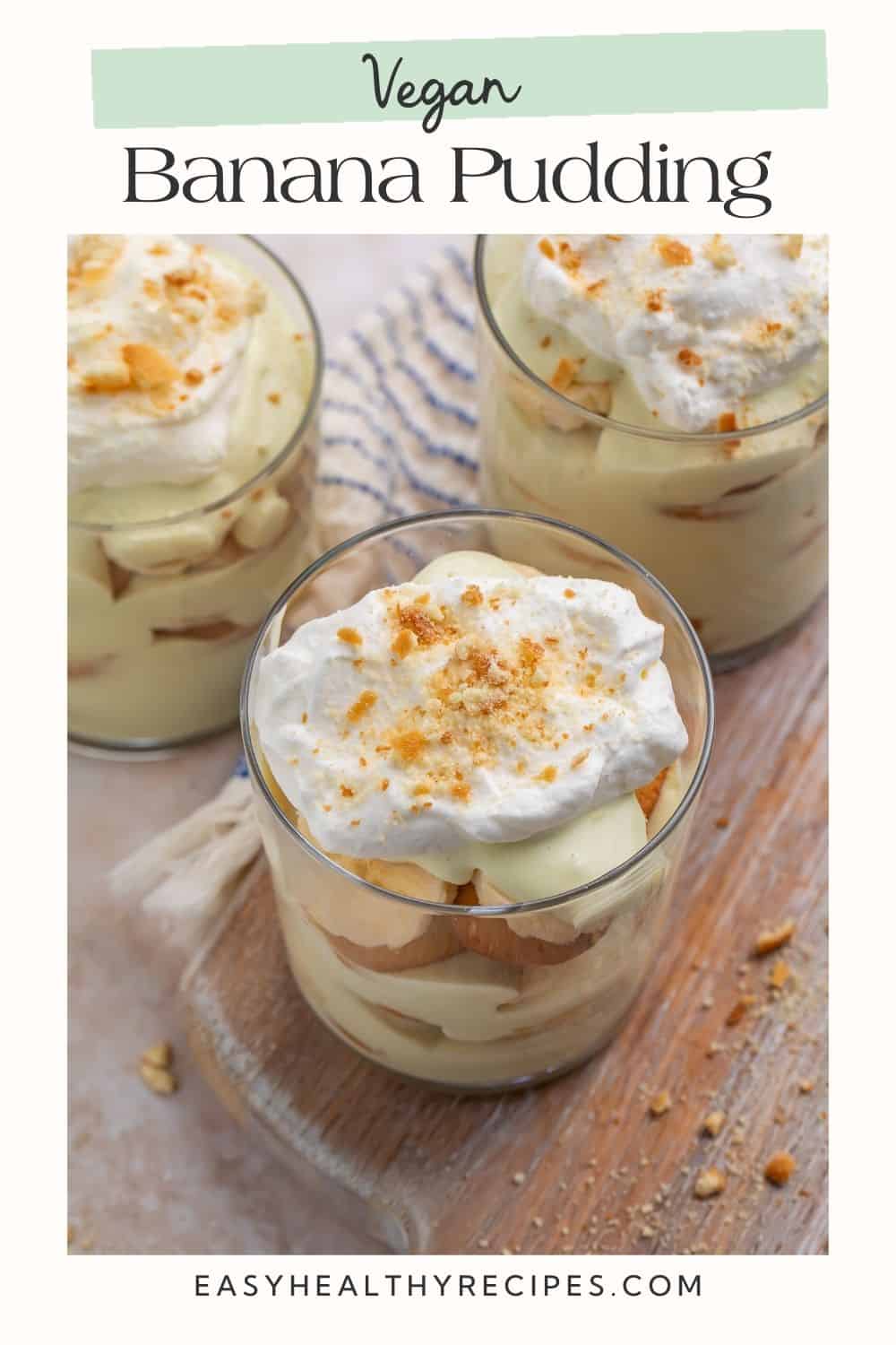 Close up of three pots of banana pudding layered with nilla wafers and vegan whipped cream. There is a frame and a Pinterest-optimised text overlay.
