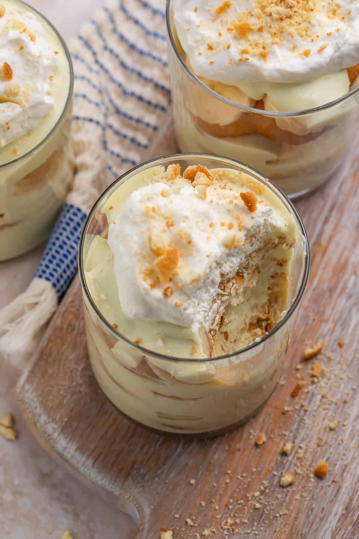 Overhead view of a portion of banana pudding with a spoonful removed to show the layers of pudding, bananas, and nilla wafers.