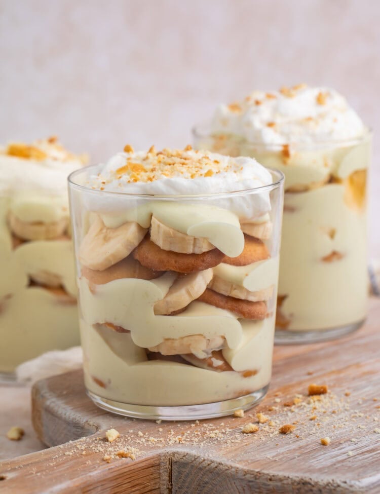 Side on view of a vegan banana pudding layered in an individual serving glass.