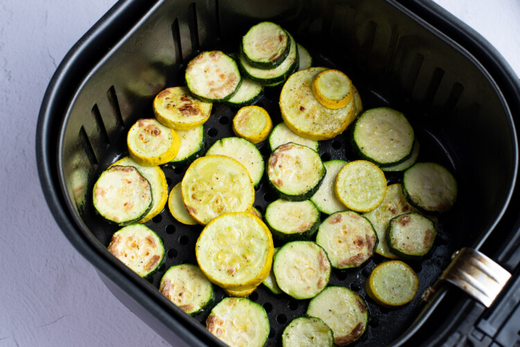 Air fried zucchini in an air fryer basket