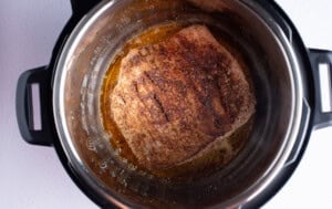Seasoned flank steak in olive oil in the Instant Pot
