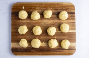 Keto empanada dough balls on a wooden cutting board