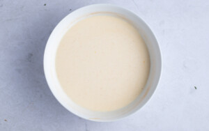 Glaze for vegan coffee cake in large white bowl