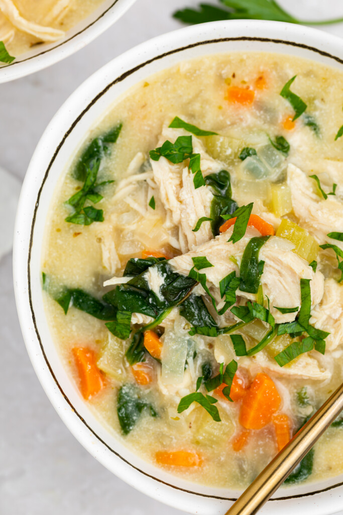 overhead and close-up image of chicken florentine soup in a bowl