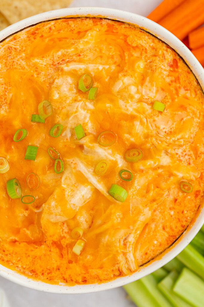 overhead closeup image of instant pot buffalo chicken dip with sliced green onions on top